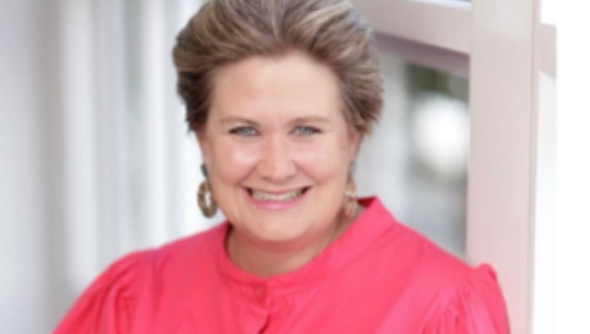 Portrait photo of Kerri-Anne Dooley in pink blouse, Founder and Director of My Care Enterprises and Home Hospice Queensland